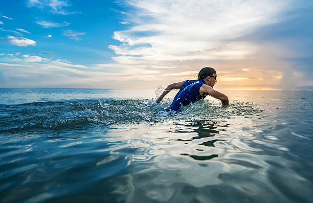 Kid exercising on sea water